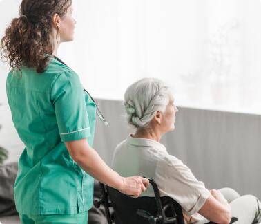 caregiver assisting elderly in a wheelchair